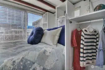 The comfortable berth includes ample built-in storage and cubbies.