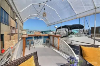 Deck features custom made built-in bar, ice chest and storage cabinets.