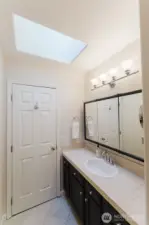 Second view of primary bath with skylight.