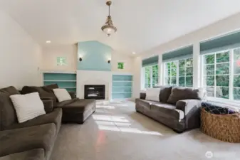 Upper living room space has an elegance about it with vaulted ceilings, french windows that allow a lot of the sun in, gas fireplace, built-ins and so on.