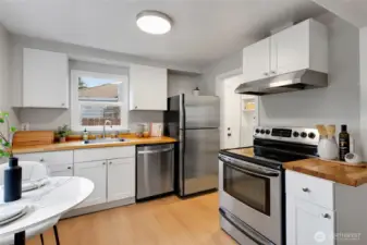 Kitchen features abundant natural light and modern appliances.