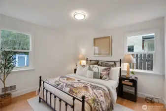 Bedroom with windows that open to the side and backyard