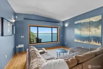 MEDIA ROOM on the upper level. Pre-wired for surround sound system. Full pull down projector screen as well, but when it's raised you have beautiful Puget Sound and Cascade Mountain views.