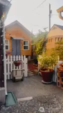 This is the separate yard for the detached studio that is used as a third bedroom.   It was built on site in the back corner of the yard.  There is a second storage shed on the property that is movable and next to the grape arbor  To the left of the studio is a path that leads to the two car garage