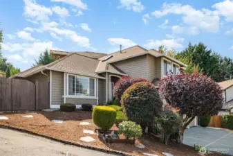 Beautiful mature landscaping creates a serene and inviting atmosphere.