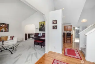 Enter into the home and be greeted by soaring vaulted ceilings and gorgeous hardwood floors.