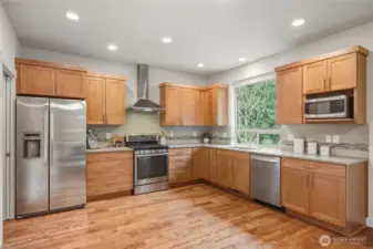 Beautiful wood cabinets and stainless steel appliances.