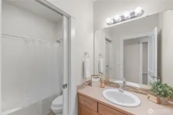 The main floor full bathroom directly across from the bedrooms.