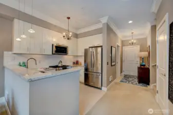 Chef's kitchen has updated quartz countertops, full height backsplash and loads of cabinet space.