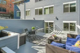 This photo shows the glass doors that connect the primary bedroom to this beautiful outdoor space.