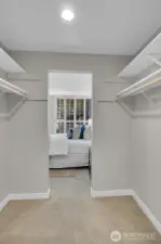 A huge walk-in closet connects the primary bedroom and bathroom.