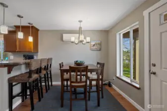 Open concept dining across from living with a view of the canal.  Additional breakfast bar seating.