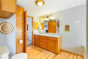 The primary bathroom has a tub, shower, and double sinks with extra storage.