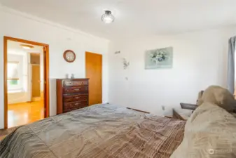 The primary bedroom has a walk-in closet in the corner, and you'll notice the shape of a doorway next to it where there used to be a door to go into the living room. The header for the former door is still in the wall should you choose to put it back in.