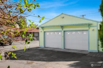 Another view of the two-car garage with window features and pergola shelf above them. This also includes a motion light feature for those dark evenings.