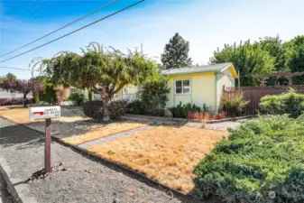 Another view of the home, secondary sidewalk and fencing on the side of the home.