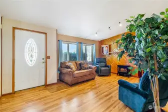 The front living room is so beautiful with all the natural lighting and wood slatted walls.