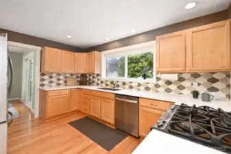 Spacious chef's kitchen with Corian countertops, designer tile, stainless steel appliances, and plenty of cabinet space. All appliances stay.