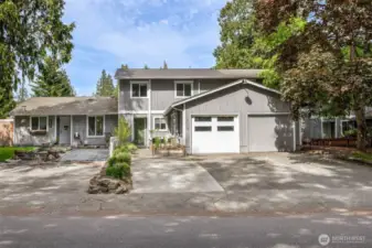 View of 3 units in the townhome complex. White garage door one with the green door is the one for sale.