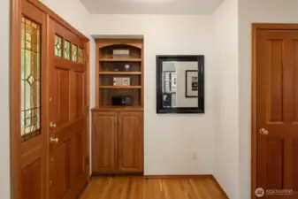 The entryway features custom built-ins thoughtfully designed for displaying your favorite books, art, or collectibles.