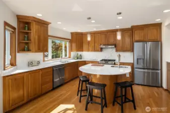 Sleek rounded island is great for combining efficiency and entertaining.