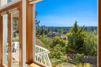 The primary bedroom features a Juliet balcony with sweeping views.