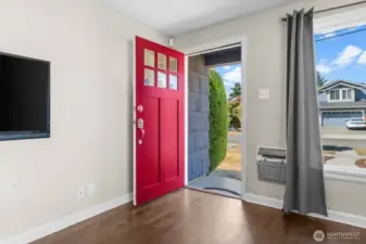 Bright and welcoming entry with natural light pouring through the front window.