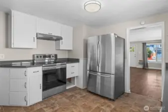 Custom built-in cabinetry provides ample storage, while maintaining the kitchen’s clean, mid-century aesthetic.