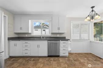 Sleek stone countertops stretch across this thoughtfully designed kitchen—perfect for meal prepping or entertaining guests.