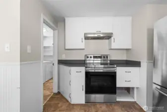 Convenient door separates the kitchen from the laundry room for added privacy and noise control