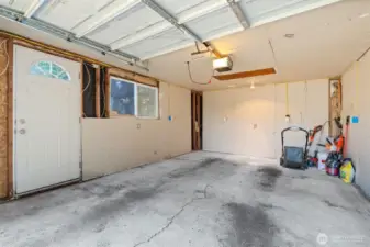 Organized garage interior with durable flooring and easy access to the yard