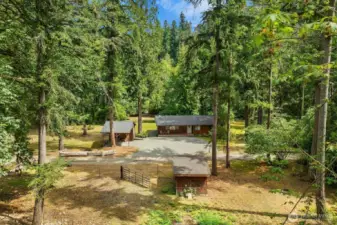 View from the acreage looking down at home, detached shed and carport and pasture outbuilding.