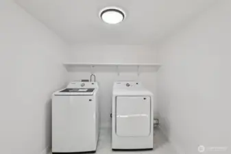 Large laundry room complete with new washer and dryer for added convenience