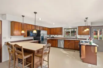 Spacious kitchen with warm wood cabinetry and generous counter space—open to the dining area for easy conversation and gatherings.