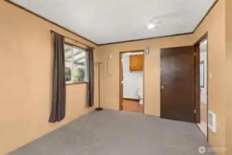 The primary bedrooms warm tones creates a cozy, welcoming atmosphere.