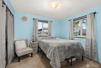 Bright secondary bedroom with peaceful views of the surrounding property.