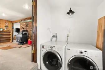 Enclosed porch/laundry/mud room with ample storage and space for freezer or extra refrigerator.