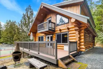 Exterior-rear of home showing proximity to sport courts, pool, and clubhouse.