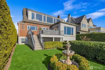 Working fountain and grassy yard ready for play, gardening, or your favorite pet!