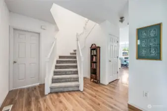 Welcome into the home with an inviting staircase.  Fresh interior paint and new floors throughout the main level allows you to move in without any work.