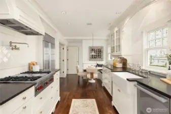 Looking the other way, you can see the breakfast nook with built-in seating and the back hall which you can enter the basement, the garage (2-car) or the side door to the outside.
