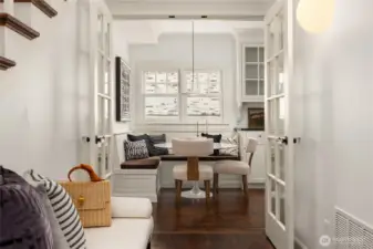 In the front hall, living room is to the right...  You get a close up of that charming nook.  Notice the divided light French doors that you can use to close off the kitchen.