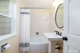 Full bath off of kitchen and near the back garage entry into the home.