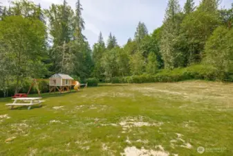 Back yard w/play structure and pic nic tables