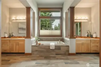 Dual vanities flank a beautifully appointed soaking tub.