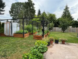 Side fence opens to another paved seating area.