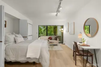 Spacious living room features new LVP light oak flooring.