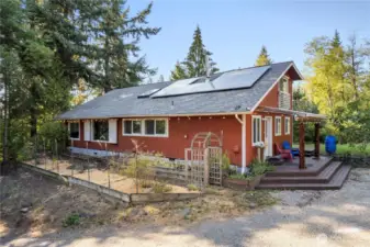 Culinary garden space just outside of the kitchen. Solar panels that feeds grid to minimize electric bill. Covered entry porch to enjoy your morning coffee.