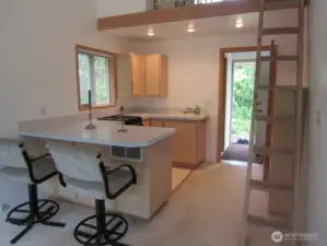 Kitchen and entry to previous apartment, now Primary Suite.