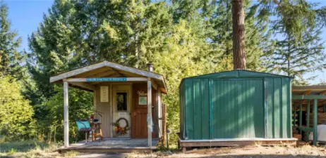 Sauna building and One of 2 insulated storage sheds and lots of outbuildings